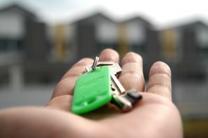 Hand holding house keys.