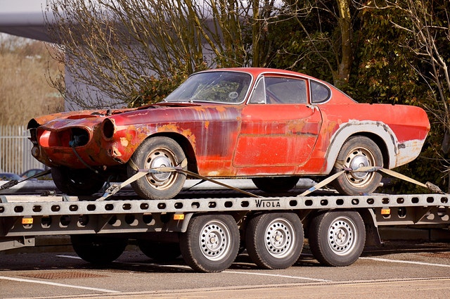 An old car on a flatbed trailer