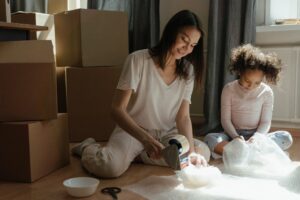 A mother and a daughter packing for NYC to Mississippi relocation
