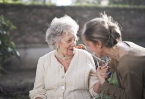 Two elderly women smiling and having fun