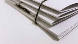 white paper folder with black string