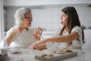 Grandmother and granddaughter baking together.